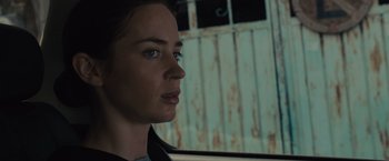 Movie still from “Sicario” (2015), directed by Denis Villeneuve – A person in a car looking at something; Close Up shot, Low angle