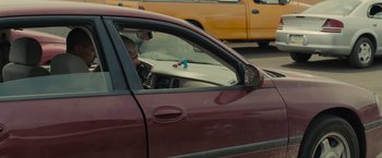 Movie still from “Sicario” (2015), directed by Denis Villeneuve – A man sitting in the driver's seat of a red car; Medium shot, High angle