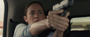 Movie still from “Sicario” (2015), directed by Denis Villeneuve – A woman holding a gun in her hand; Close Up shot, Over the shoulder angle