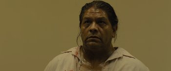 Movie still from “Sicario” (2015), directed by Denis Villeneuve – A person wearing a white shirt; Close Up shot, Low angle