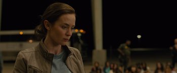 Movie still from “Sicario” (2015), directed by Denis Villeneuve – A woman standing in front of a group of people; Close Up shot, Over the shoulder angle
