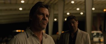 Movie still from “Sicario” (2015), directed by Denis Villeneuve – A man standing next to another man in front of a building; Close Up shot, Over the shoulder angle