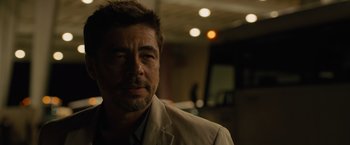 Movie still from “Sicario” (2015), directed by Denis Villeneuve – A person wearing a suit; Close Up shot, Over the shoulder angle