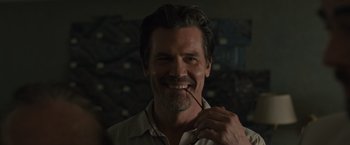 Movie still from “Sicario” (2015), directed by Denis Villeneuve – A person holding a stick in his mouth; Close Up shot, Over the shoulder angle