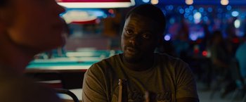 Movie still from “Sicario” (2015), directed by Denis Villeneuve – A person sitting at a table; Close Up shot, Over the shoulder angle