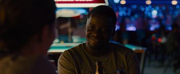 Movie still from “Sicario” (2015), directed by Denis Villeneuve – A person sitting at a table holding a beer; Close Up shot, Over the shoulder angle