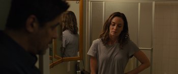 Movie still from “Sicario” (2015), directed by Denis Villeneuve – A woman standing in front of a bathroom mirror; Medium shot, Over the shoulder angle