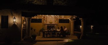 Movie still from “Sicario” (2015), directed by Denis Villeneuve – A group of people sitting at a table in the dark; Extreme Wide shot, High angle