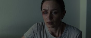 Movie still from “Sicario” (2015), directed by Denis Villeneuve – A person with a bruised eye; Close Up shot, Over the shoulder angle