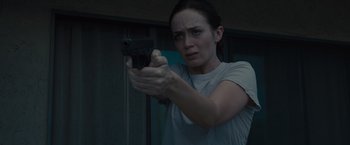 Movie still from “Sicario” (2015), directed by Denis Villeneuve – A woman is holding a gun in her hand; Close Up shot, Low angle