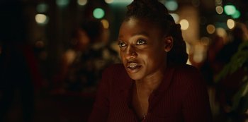 Movie still from “Top Boy” (2011), created by Ronan Bennett – A person sitting in front of a window; Close Up shot, Over the shoulder angle