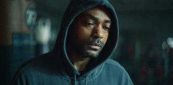 Movie still from “Top Boy” (2011), created by Ronan Bennett – A person wearing a hooded sweatshirt; Close Up shot, Low angle