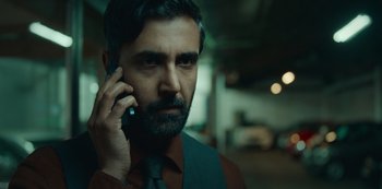 Movie still from “Top Boy” (2011), created by Ronan Bennett – A person talking on a cell phone; Close Up shot, Low angle