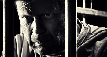 Movie still from “Sin City” (2005), directed by Frank Miller – Black and white photograph of a man's face and beard; Close Up shot, Low angle