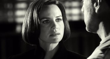 Movie still from “Sin City” (2005), directed by Frank Miller – Black and white photograph of a woman with short hair; Close Up shot, Over the shoulder angle