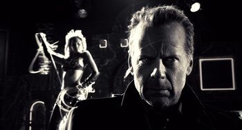 Movie still from “Sin City” (2005), directed by Frank Miller – A black and white photo of a man and a woman; Close Up shot, Low angle