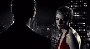 Movie still from “Sin City” (2005), directed by Frank Miller – A man and a woman are standing in front of each other; Close Up shot, Low angle