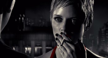 Movie still from “Sin City” (2005), directed by Frank Miller – A woman smoking a cigarette in a black and white photo; Close Up shot, Low angle