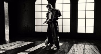 Movie still from “Sin City” (2005), directed by Frank Miller – A black and white photo of a man in a robe; Wide shot, Low angle