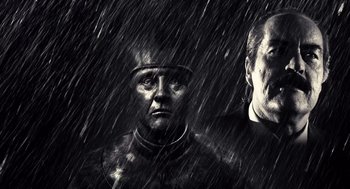 Movie still from “Sin City” (2005), directed by Frank Miller – A man in a suit and helmet in the rain; Close Up shot, Low angle