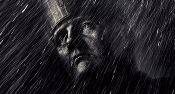 Movie still from “Sin City” (2005), directed by Frank Miller – A statue in the middle of a rain storm; Extreme Close Up shot, Low angle
