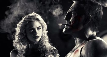 Movie still from “Sin City” (2005), directed by Frank Miller – A man and a woman are smoking a cigarette together; Close Up shot, Low angle