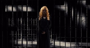 Movie still from “Sin City” (2005), directed by Frank Miller – A woman standing in front of a jail cell; Wide shot, Low angle