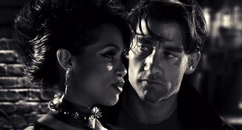 Movie still from “Sin City” (2005), directed by Frank Miller – A man and a woman standing next to each other; Close Up shot, Low angle