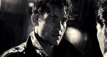 Movie still from “Sin City” (2005), directed by Frank Miller – Black and white photograph of a man with wet hair; Close Up shot, Low angle