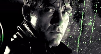 Movie still from “Sin City” (2005), directed by Frank Miller – A person wearing a black jacket; Extreme Close Up shot, Low angle