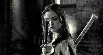 Movie still from “Sin City” (2005), directed by Frank Miller – A young woman holding a sword in her hand; Close Up shot, Low angle