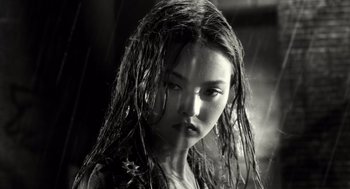 Movie still from “Sin City” (2005), directed by Frank Miller – A young woman with wet hair and a black shirt; Close Up shot, Low angle