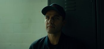 Movie still from “Triple Frontier” (2019), directed by J.C. Chandor – A person wearing a hat; Close Up shot, Over the shoulder angle