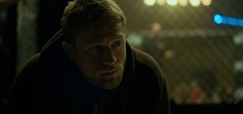 Movie still from “Triple Frontier” (2019), directed by J.C. Chandor – A person wearing a jacket; Close Up shot, Over the shoulder angle