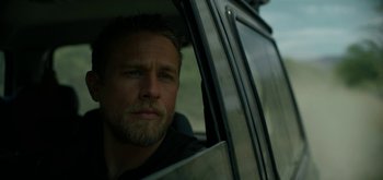 Movie still from “Triple Frontier” (2019), directed by J.C. Chandor – A person sitting in a car; Close Up shot, Over the shoulder angle