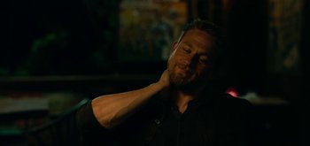 Movie still from “Triple Frontier” (2019), directed by J.C. Chandor – A person with his hand behind his neck; Close Up shot, Over the shoulder angle