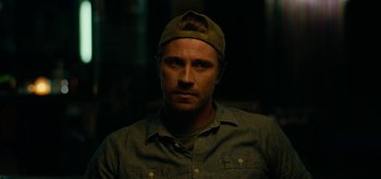 Movie still from “Triple Frontier” (2019), directed by J.C. Chandor – A person wearing a hat; Close Up shot, Low angle