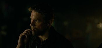 Movie still from “Triple Frontier” (2019), directed by J.C. Chandor – A person wearing a black shirt; Close Up shot, Over the shoulder angle