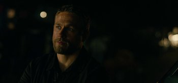 Movie still from “Triple Frontier” (2019), directed by J.C. Chandor – A person wearing a black shirt; Close Up shot, Over the shoulder angle