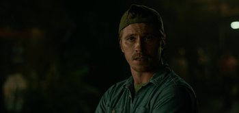 Movie still from “Triple Frontier” (2019), directed by J.C. Chandor – A person wearing a hat; Close Up shot, Over the shoulder angle