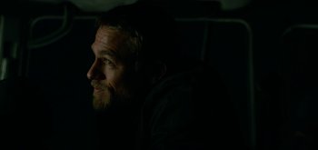 Movie still from “Triple Frontier” (2019), directed by J.C. Chandor – A person sitting in a dark room; Close Up shot, Over the shoulder angle