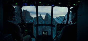 Movie still from “Triple Frontier” (2019), directed by J.C. Chandor – A view from inside an airplane of mountains; Extreme Wide shot, High angle