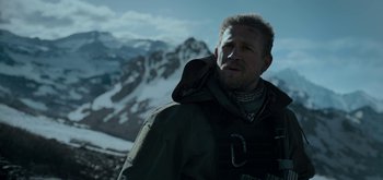 Movie still from “Triple Frontier” (2019), directed by J.C. Chandor – A person standing in the snow; Close Up shot, Low angle