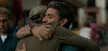 Movie still from “Triple Frontier” (2019), directed by J.C. Chandor – Two men hugging each other in a room; Close Up shot, Over the shoulder angle