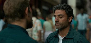 Movie still from “Triple Frontier” (2019), directed by J.C. Chandor – A man with his eyes closed and another man with his hands in his pockets; Close Up shot, Over the shoulder angle