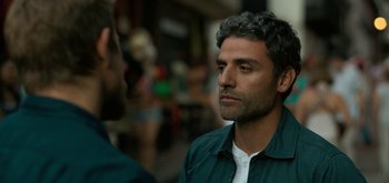 Movie still from “Triple Frontier” (2019), directed by J.C. Chandor – A man in a green shirt is talking to another man in a white shirt; Close Up shot, Over the shoulder angle