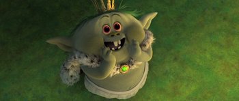 Movie still from “Trolls” (2016), directed by Mike Mitchell – An animated troll sitting on top of a chair in the grass; Close Up shot, High angle