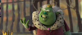 Movie still from “Trolls” (2016), directed by Mike Mitchell – A green troll with a crown on his head; Medium shot, High angle