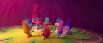 A group of trolls sitting on the ground