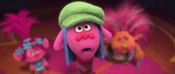 Movie still from “Trolls” (2016), directed by Mike Mitchell – A troll doll wearing a green hat; Close Up shot, Low angle